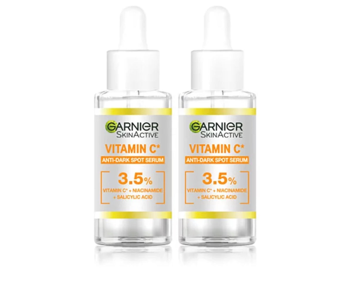 Garnier Vitamin C Anti-Dark Spot Brightening Serum bottles, 2 x 30ml, with vibrant orange packaging and dropper applicators.